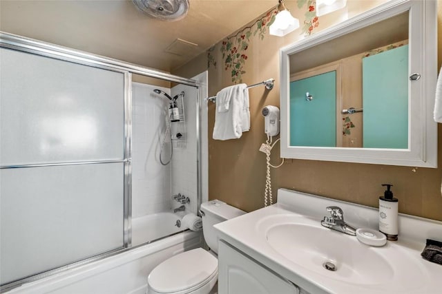 full bathroom with vanity, enclosed tub / shower combo, and toilet