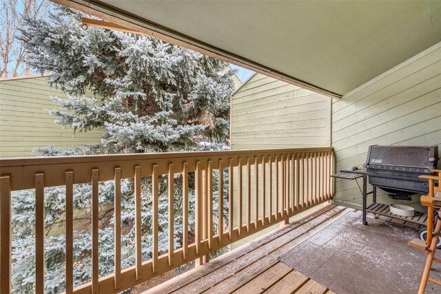 view of snow covered back of property