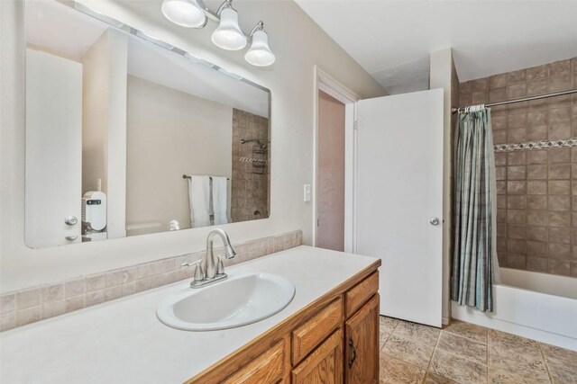 bathroom featuring vanity, a shower with door, and a notable chandelier