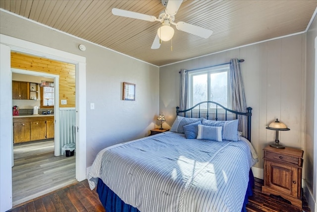 bedroom with ornamental molding, a ceiling fan, wood ceiling, and wood finished floors