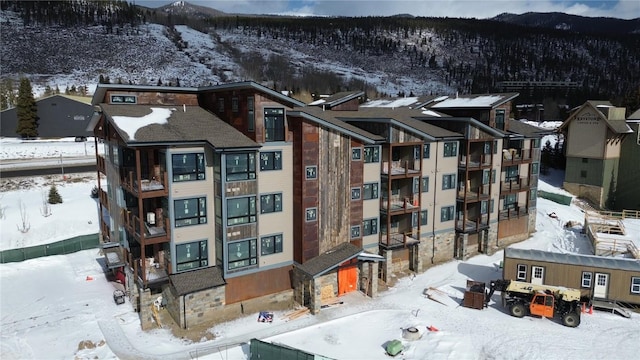 snowy aerial view featuring a mountain view