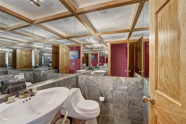 bathroom featuring beam ceiling, toilet, coffered ceiling, and sink