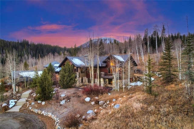 back house at dusk with a mountain view