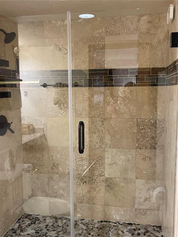 full bath with a shower stall