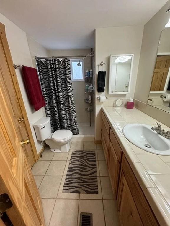 full bath featuring tile patterned flooring, toilet, vanity, visible vents, and a shower stall