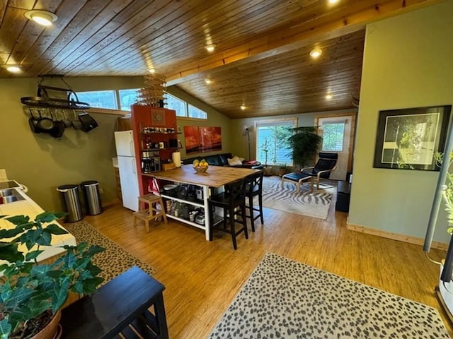 dining area featuring wood ceiling, vaulted ceiling, light wood-style flooring, and baseboards