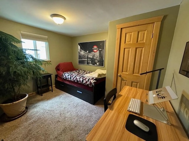 bedroom featuring carpet and baseboards