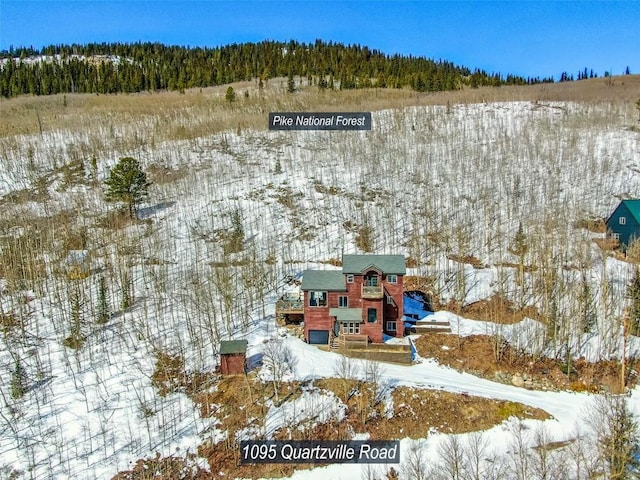 snowy aerial view with a forest view