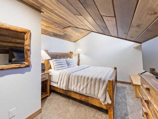 carpeted bedroom with vaulted ceiling and wooden ceiling