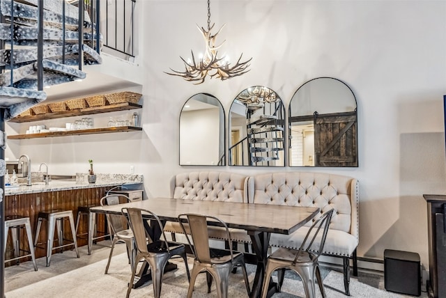 dining space with sink and an inviting chandelier