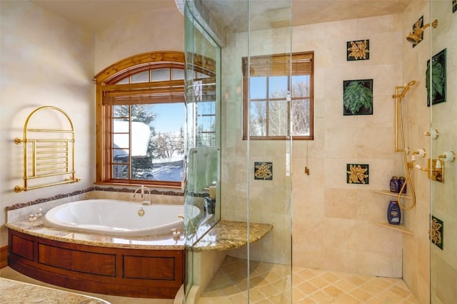 bathroom with a healthy amount of sunlight and shower with separate bathtub