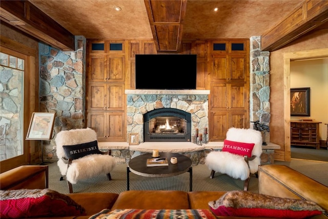 living room featuring wood walls, beamed ceiling, and a stone fireplace