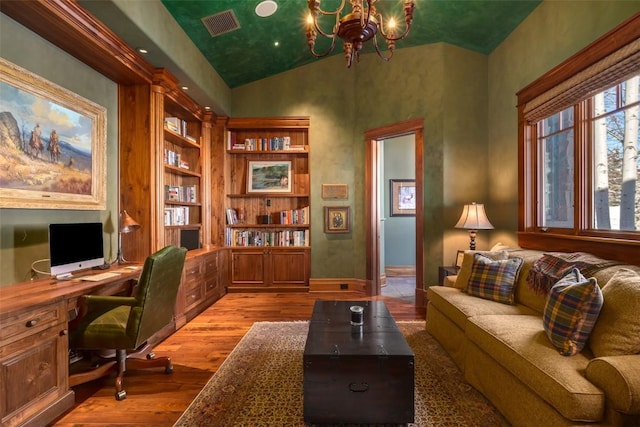 office featuring light wood-type flooring, vaulted ceiling, and a notable chandelier