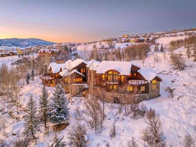 snowy aerial view with a mountain view