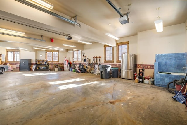 garage featuring a garage door opener and a workshop area