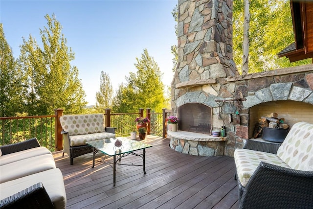 wooden terrace with an outdoor stone fireplace