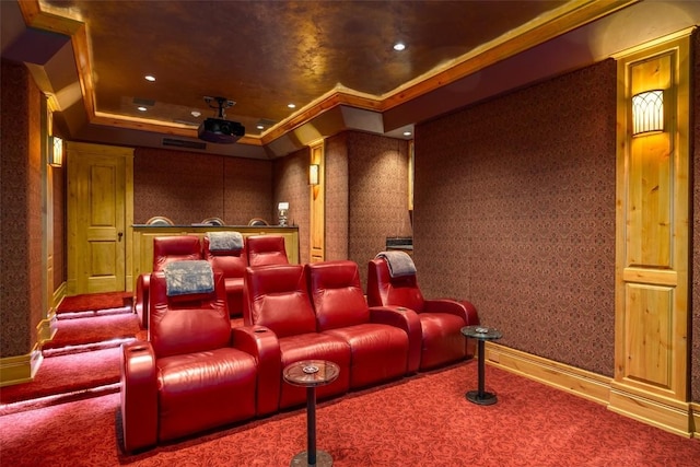 home theater room with carpet, a tray ceiling, and ornamental molding