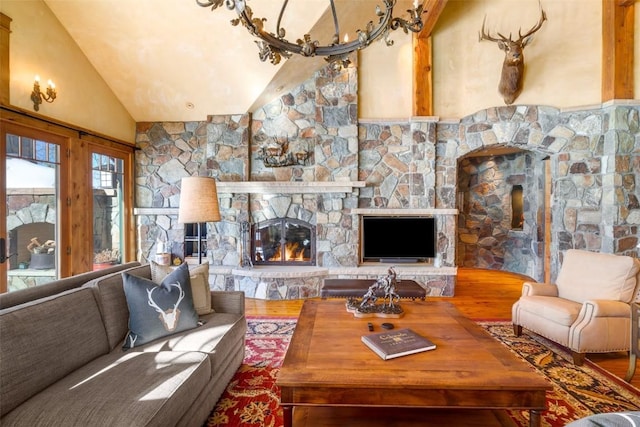 living room with a fireplace, hardwood / wood-style flooring, and lofted ceiling