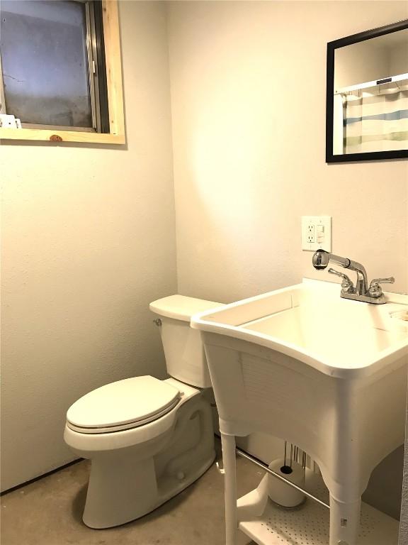 bathroom with toilet and a sink