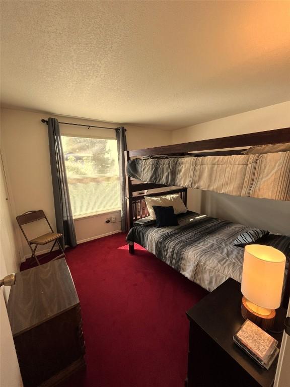 carpeted bedroom featuring a textured ceiling