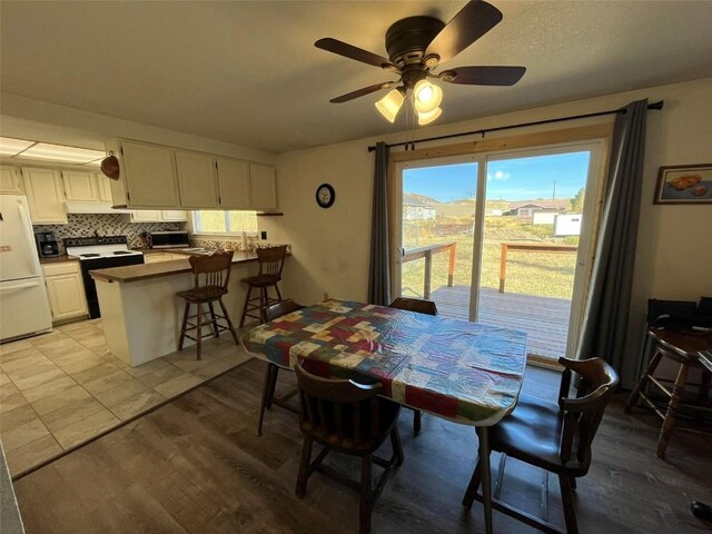 dining area with light wood-style flooring and ceiling fan