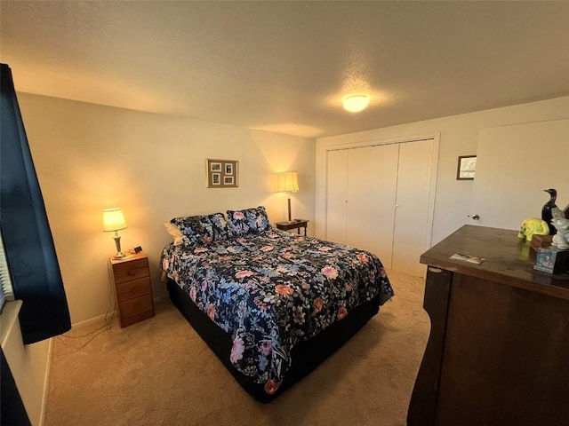 bedroom featuring a closet, light colored carpet, and a textured ceiling