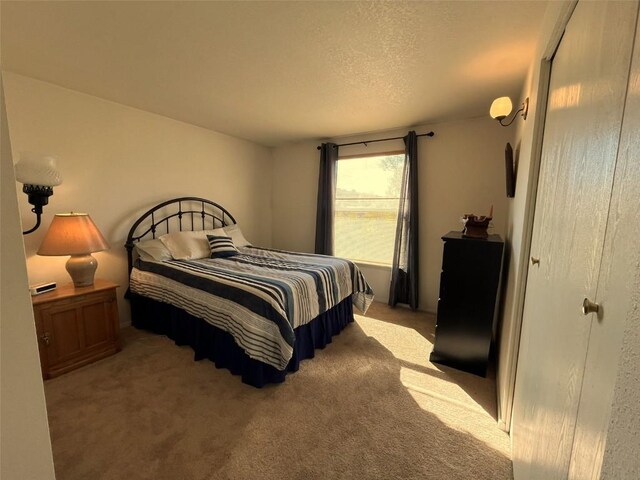 carpeted bedroom featuring a textured ceiling