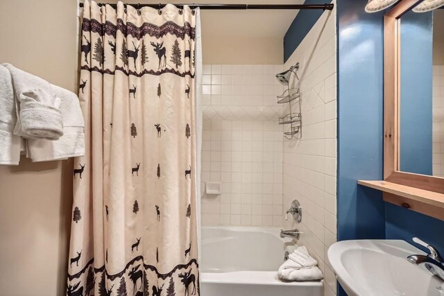 bathroom with sink and shower / tub combo with curtain