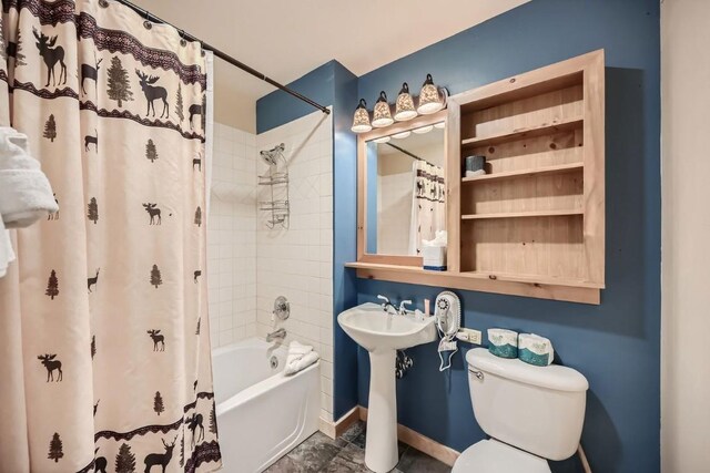 bathroom featuring shower / bath combination with curtain and toilet