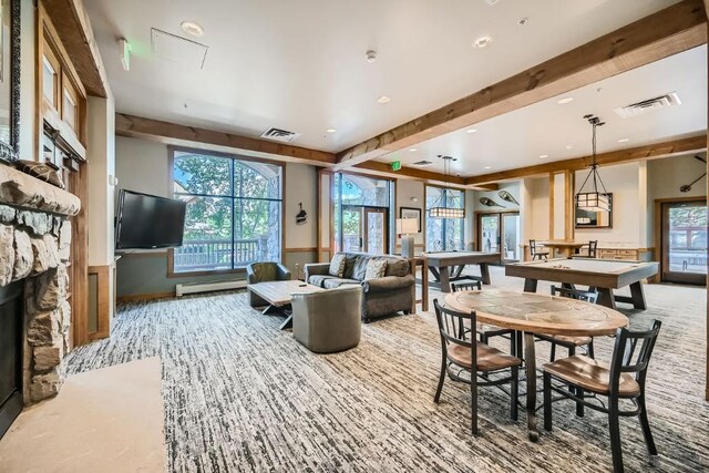 interior space with a baseboard radiator, beamed ceiling, billiards, light carpet, and a fireplace