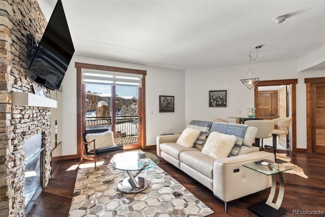 living room featuring dark hardwood / wood-style flooring and a fireplace