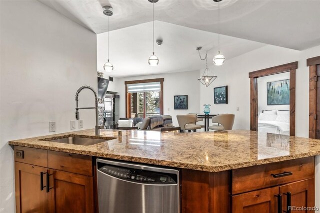 kitchen featuring dishwasher, light stone countertops, sink, and decorative light fixtures