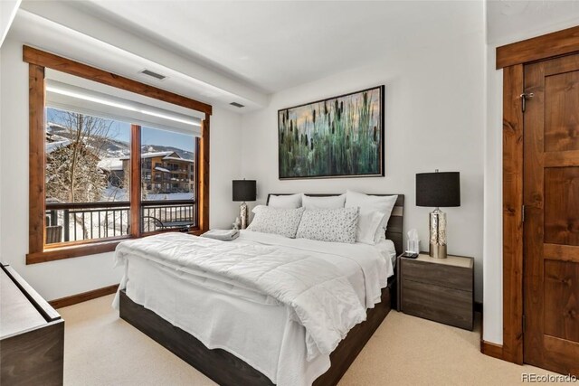 bedroom featuring light colored carpet