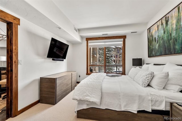 bedroom featuring light colored carpet and access to outside