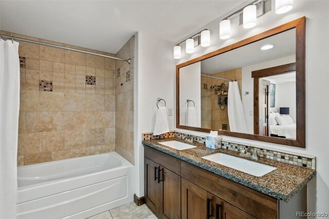 bathroom featuring tile patterned floors, decorative backsplash, shower / bath combo with shower curtain, and vanity