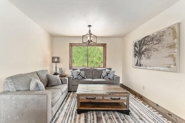 living room featuring a chandelier and wood-type flooring