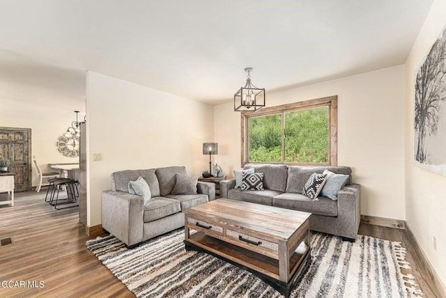 living room featuring hardwood / wood-style floors and an inviting chandelier