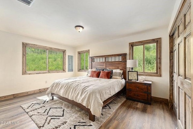 bedroom featuring wood-type flooring and electric panel