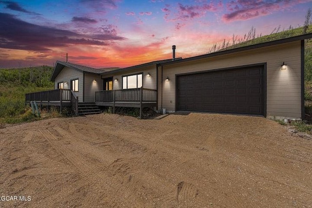 view of front of house featuring a garage and a wooden deck