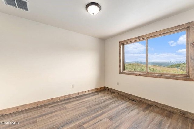 unfurnished room featuring hardwood / wood-style floors