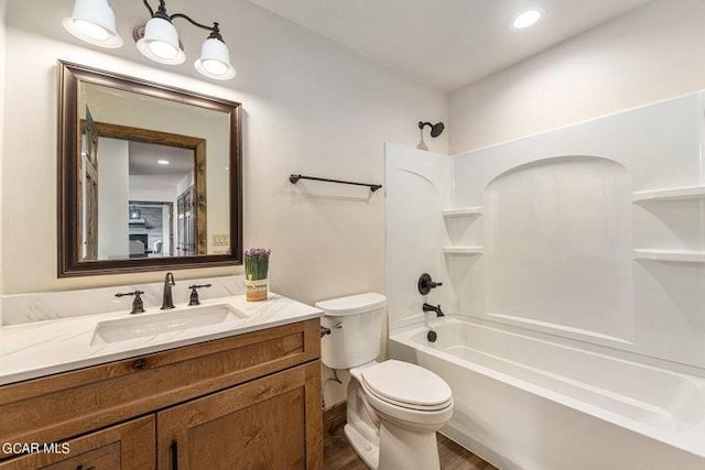 full bathroom with vanity,  shower combination, toilet, and wood-type flooring