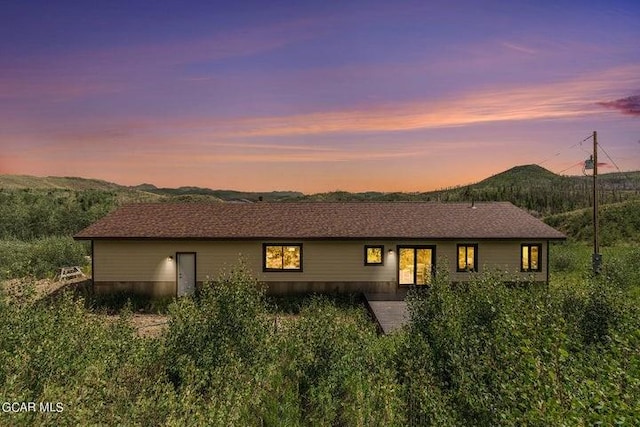 back house at dusk featuring a mountain view