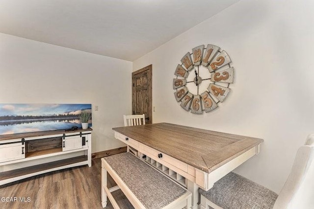 dining area featuring dark wood-type flooring