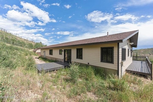 back of property with a wooden deck