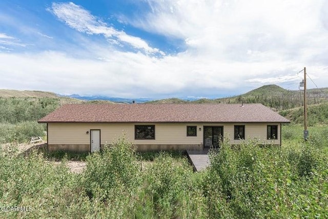 back of house with a mountain view