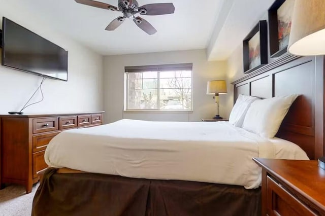 bedroom featuring light carpet and ceiling fan