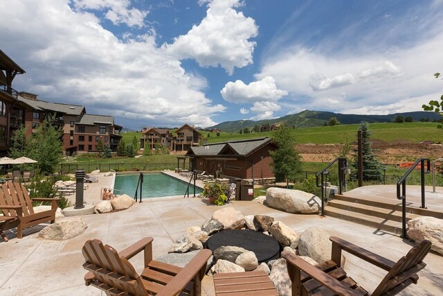 pool with a patio and a mountain view