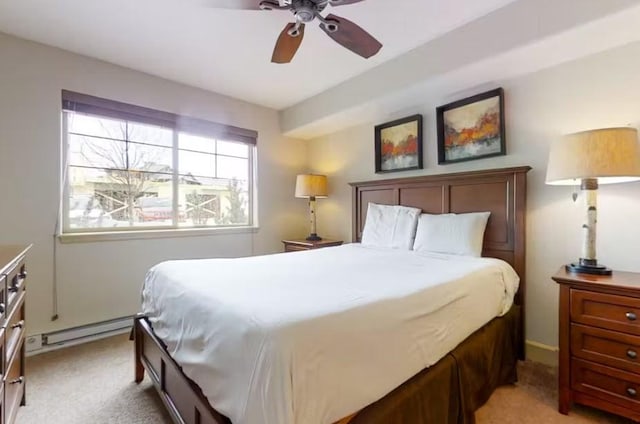 bedroom featuring a baseboard heating unit, a ceiling fan, and light colored carpet