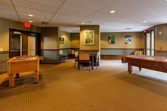 recreation room with carpet, a wainscoted wall, a drop ceiling, and recessed lighting