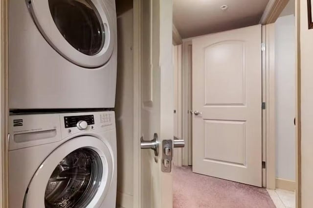 washroom featuring stacked washer / drying machine